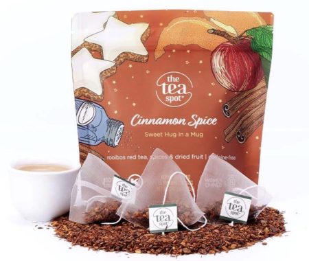 Cinnamon spice rooibos tea pouch with pyramid sachets, loose rooibos, and a creamy brewed cup at SereniTea Boutique