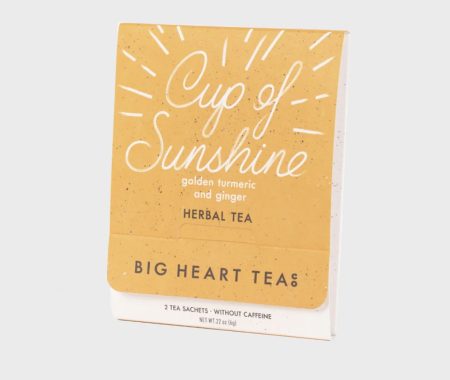 Cup of Sunshine golden turmeric and ginger herbal tea sachet pack at SereniTea Boutique