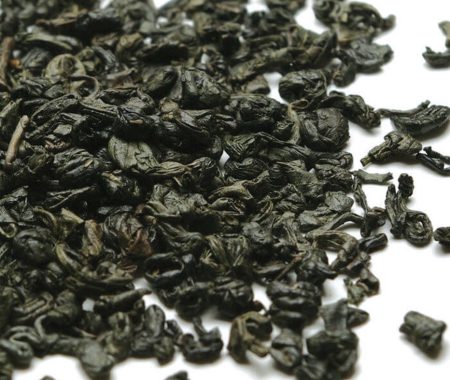 Tightly rolled gunpowder green tea pellets in a close up at SereniTea Boutique